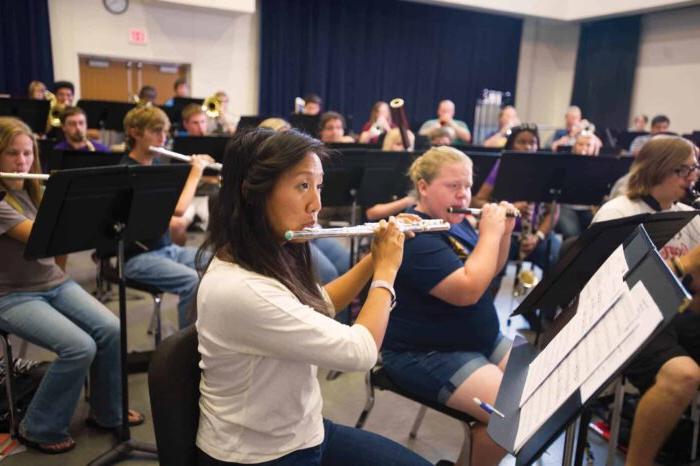 a group of people playing instruments in a room.