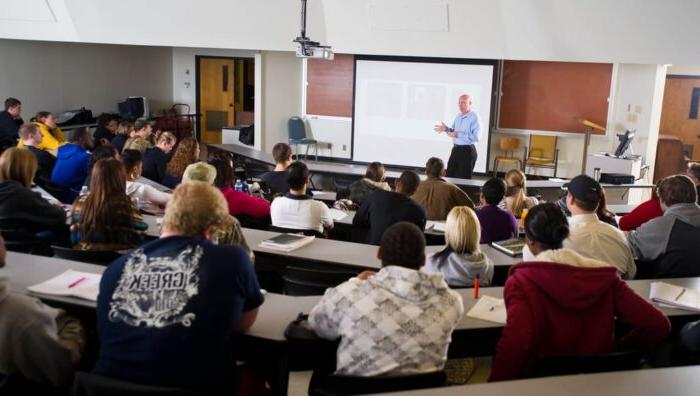 Instructor teaching in front of class.