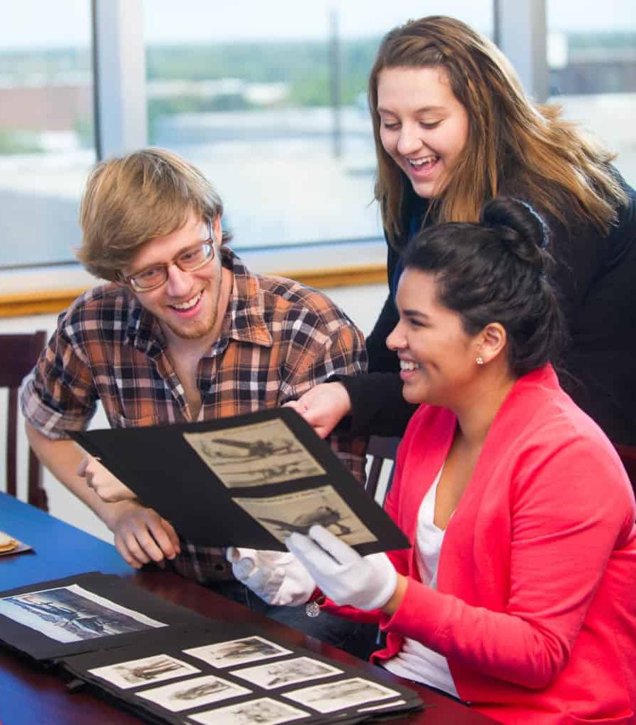 Students looking at historic photographs.