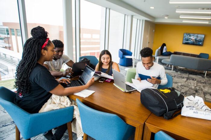 A group of students studying together sitting at a table.