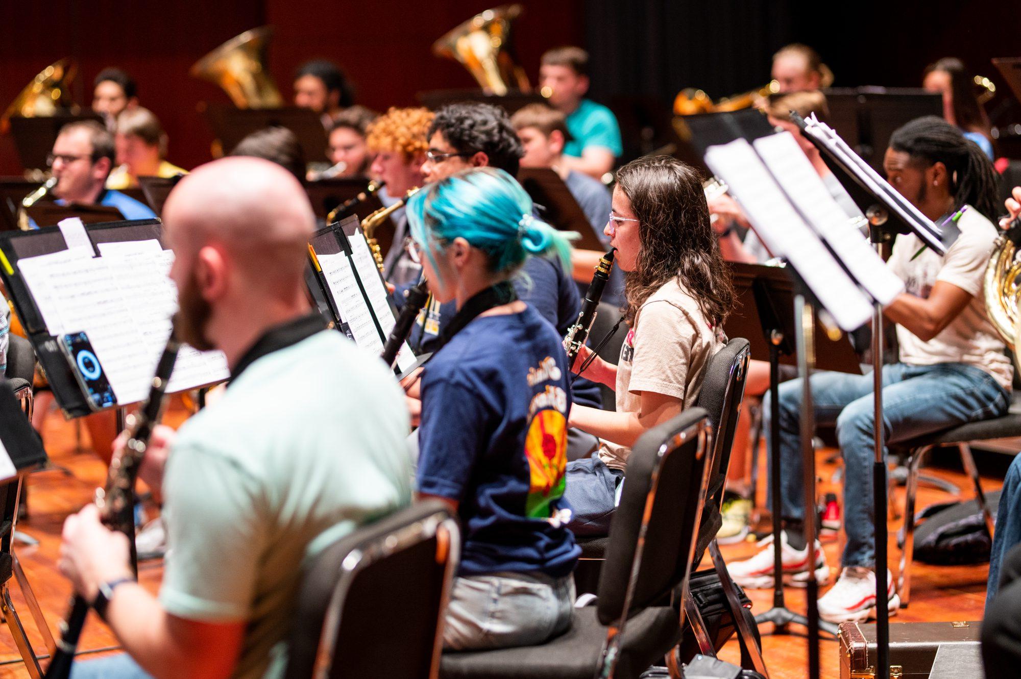 A group of students in the classroom playing clarinet.