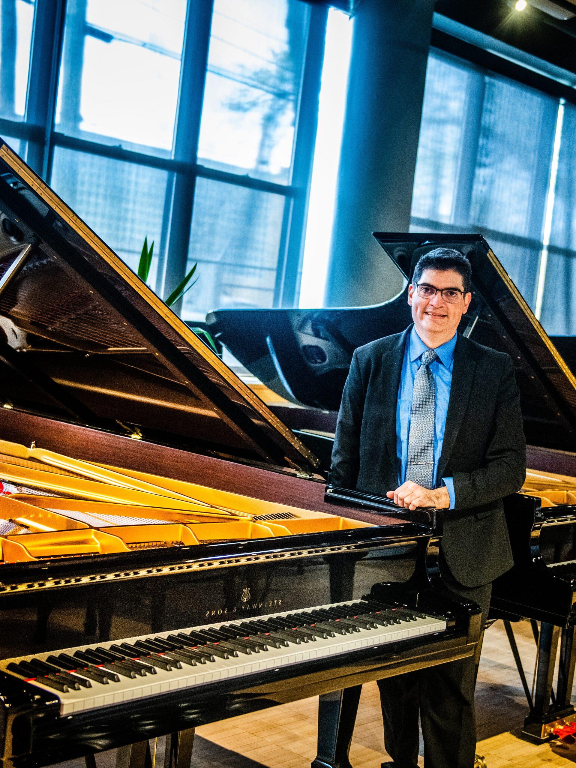 Dr. Sanchez by a piano.