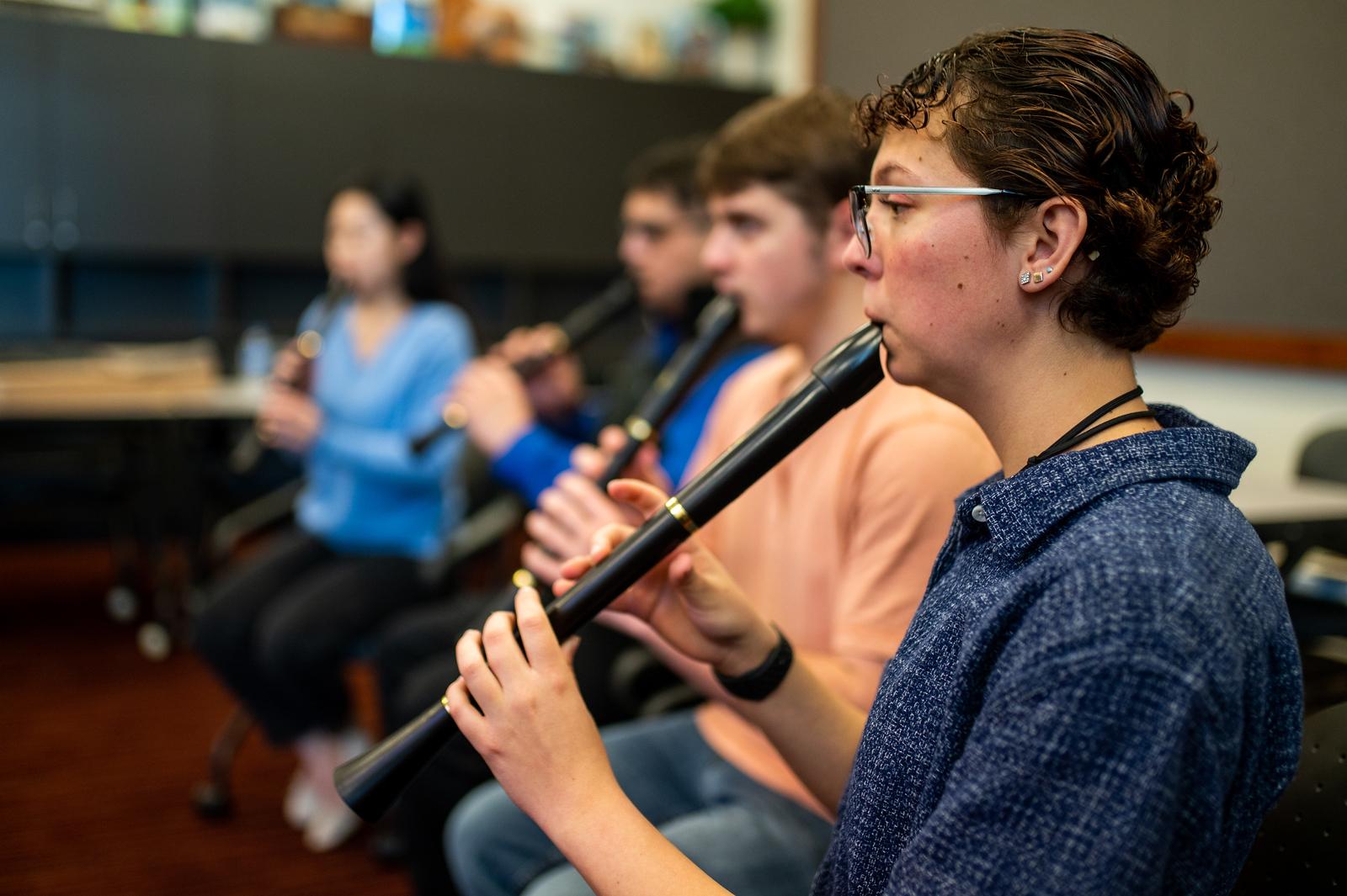 A group of students playing the flute.